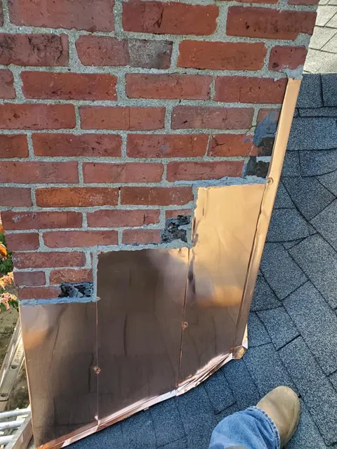 Stone and brick chimney flashing